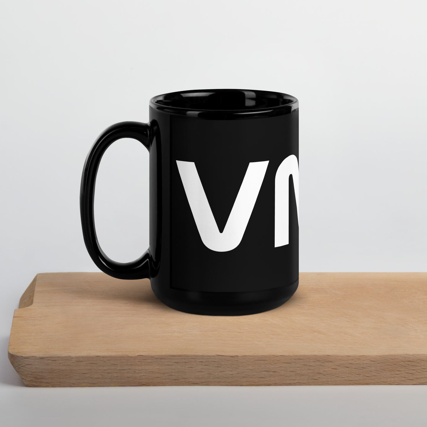 side view of black glossy 15oz mug with the handle on the left
