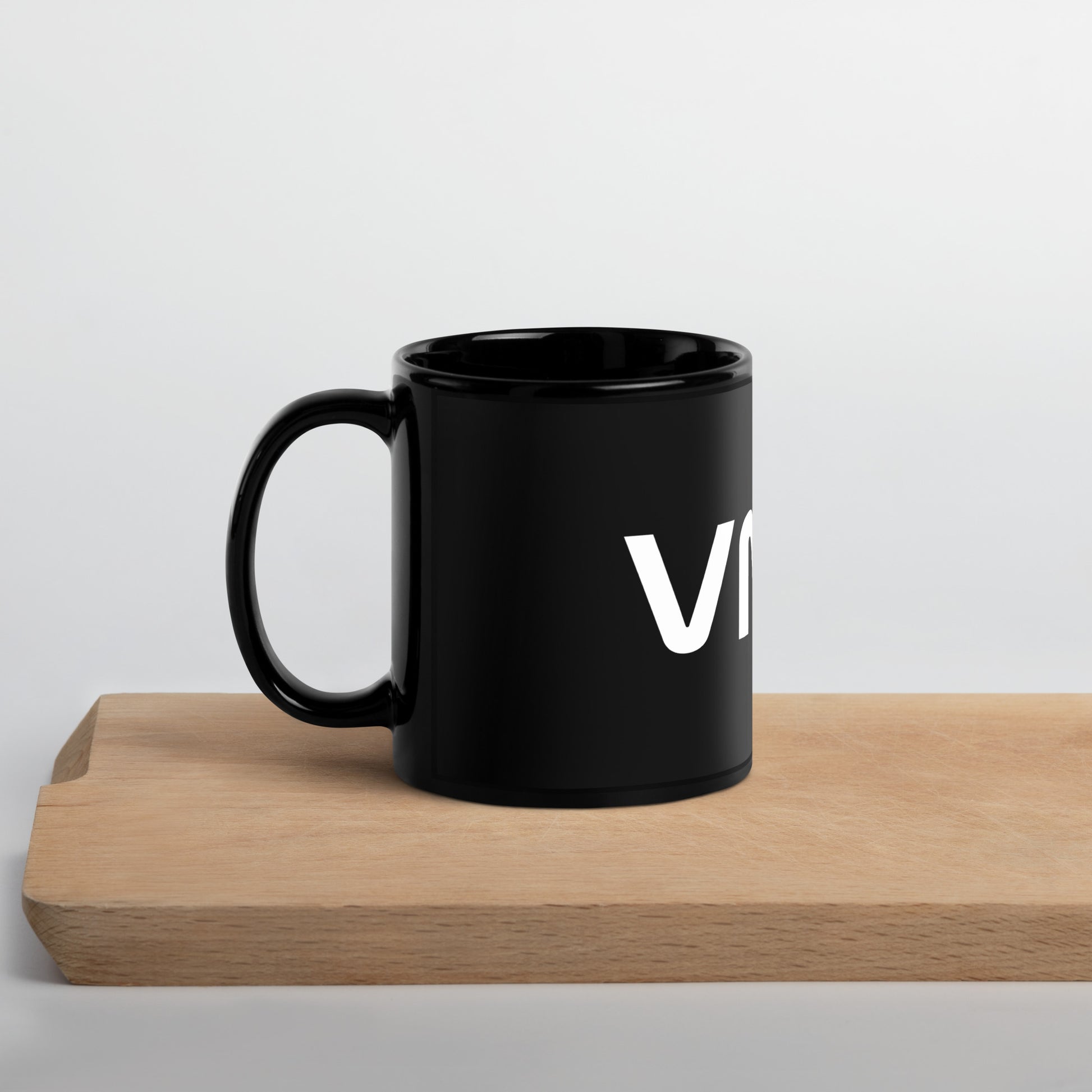side view of black glossy 11oz mug with the handle on the left